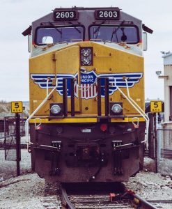 Head-on approach of a Union Pacific locomotive on railroad tracks